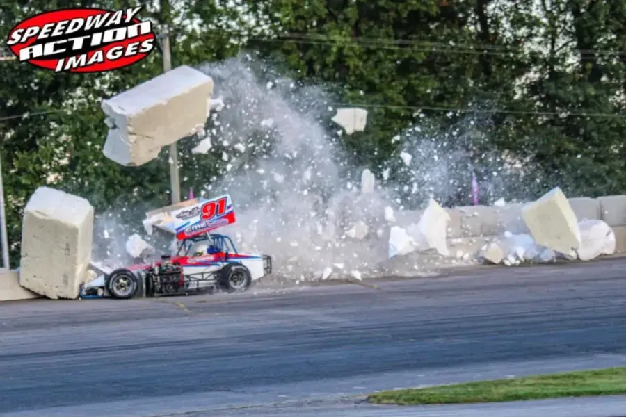 A sprint car sends the foam blocks flying in the turn