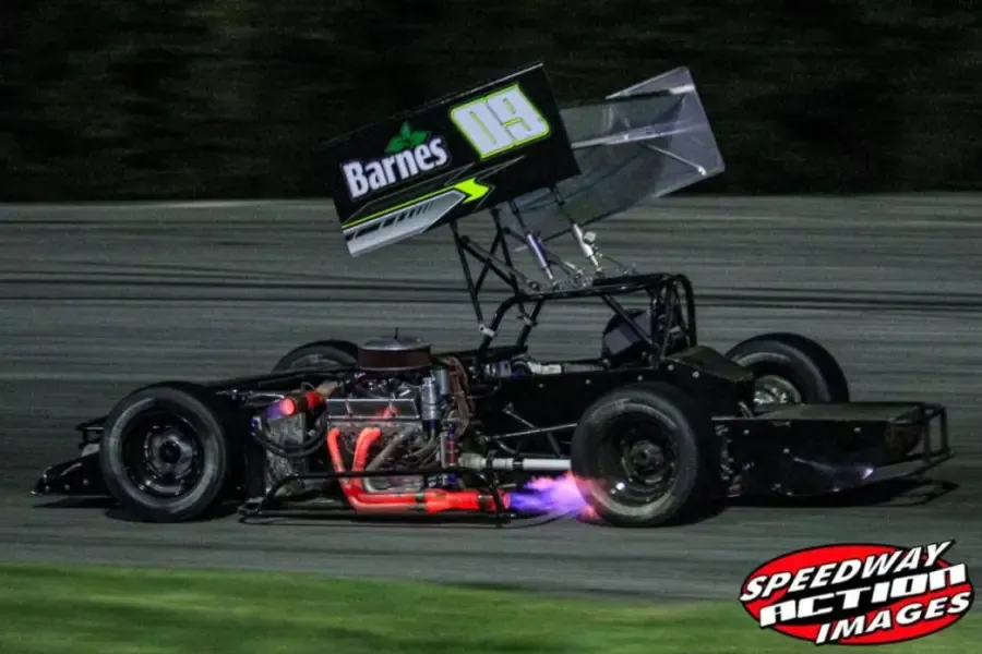 The 09 supermodified racing at night with flames from the exhaust
