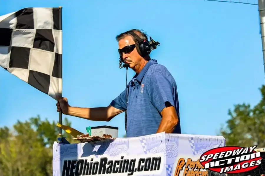 The flagman holding the checkered flag