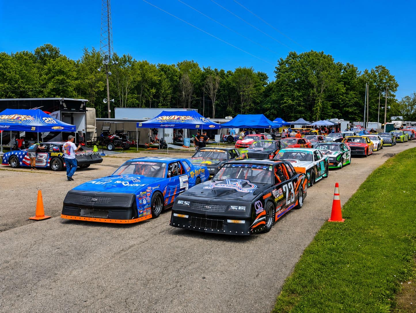 Race cars and haulers in the pit area